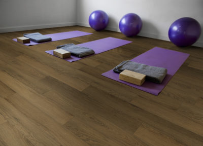 Three purple mats on a yoga classroom | UCX